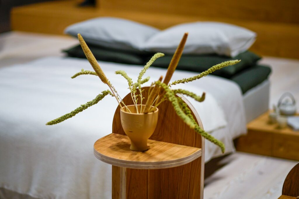 Calm Japandi bedroom with natural wood, linen bedding, soft neutral colors, and warm daylight