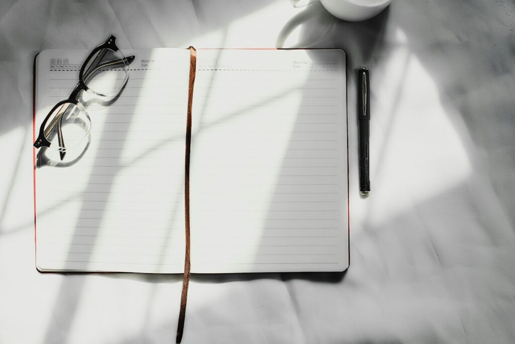 Open notebook and pen on a clean desk for a simple weekly planning reset